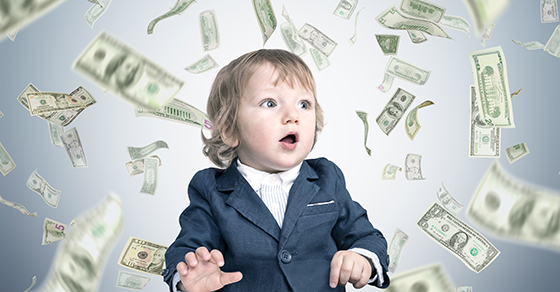 Small child sitting surrounded by floating dollar bills